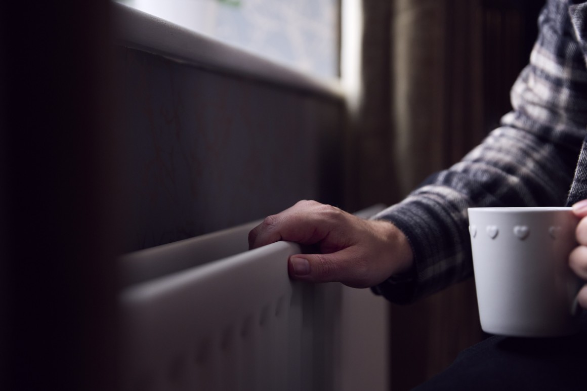 Mature hand near heater