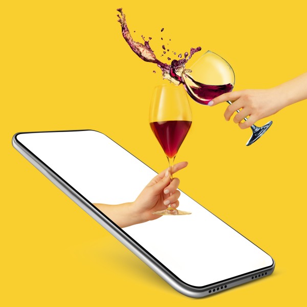 Hand holding wineglass coming out of cellphone